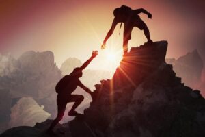 woman receiving help while climbing