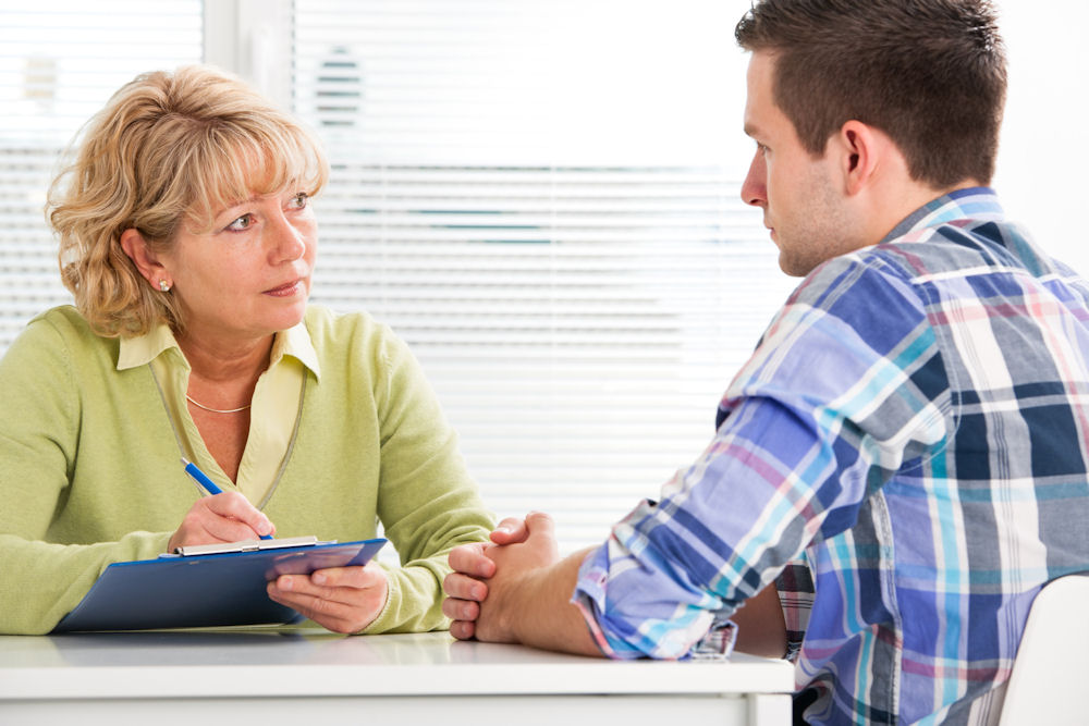 a man with addiction problem talking to a therapist